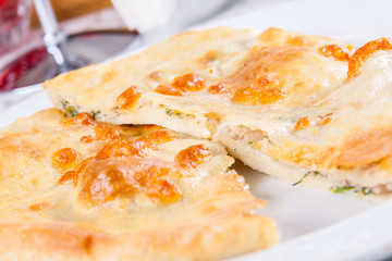 Khachapuri with meat on white plate
