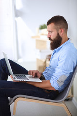 Young businessman sitting on chair in office