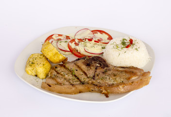 Grilled steak pork meat with salad, rice, potatoes, tomatoes