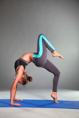 Portrait of sport girl doing yoga stretching exercise