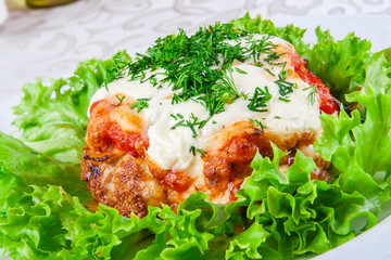 Armenian kyufta baked with cheese and tomato sauce