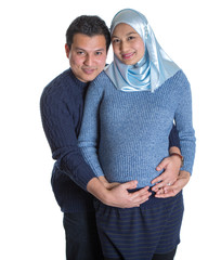 Young happy Muslim pregnant couple over white background - 100905084