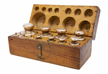 Vintage box with brass weights unit arranged in two row on white background
