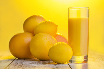 Glass of orange juice standing on the table 