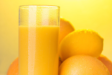 Glass of orange juice standing on the table 