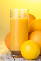 Glass of orange juice standing on the table 