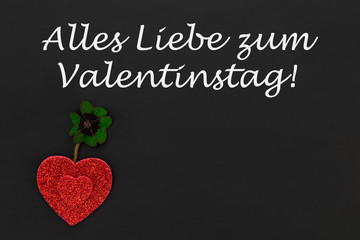 rote Herzen und ein Kleeblatt auf einer Tafel