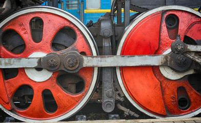 Train drive mechanism and red wheels of an old  steam locomotive