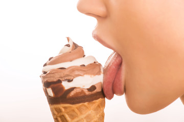 Young girl licking an ice cream. - obrazy, fototapety, plakaty