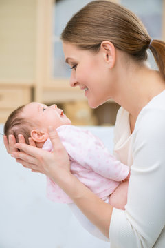 Loving nursing mother holding infant 