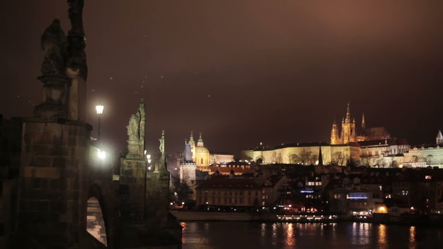 Night panoramic scenic view of Charles bridge with antique statues over Vltava river and of historical center of Prague – Castle in a distance, buildings and landmarks of old town