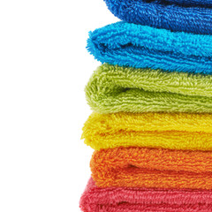 Pile of rainbow colored towels isolated