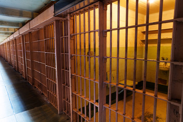Row of prison cells with inside view