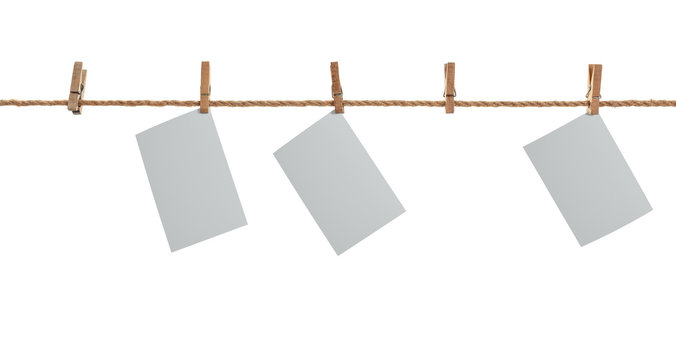 white photo paper. Hanging on a clothesline with clothespins.
