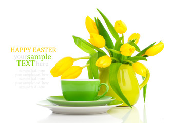 coffee cup with yellow tulips, on white background.