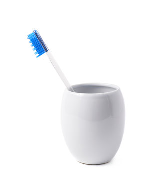 Blue Toothbrush In A Cup Isolated