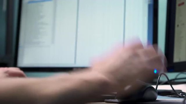 Person using home computer with two monitors.
