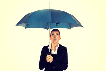 Surprised businesswoman holding an umbrella