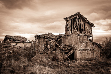 ruins of abandoned rustic houses made of wood and clay