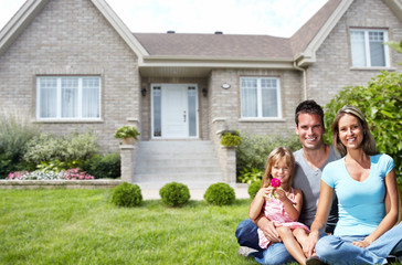 Happy family near new house.