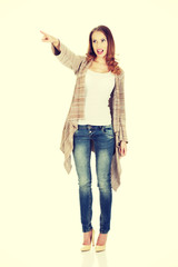 Shocked woman pointing away.