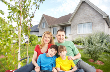 Happy family near new house.