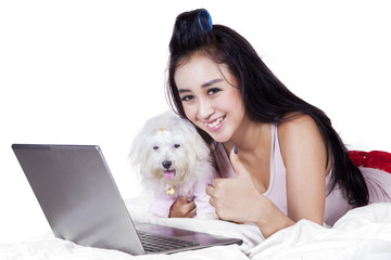 Cute girl with dog showing thumb up