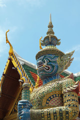 Fototapeta premium Ancient sculpture of thai demon on traditional roof background 