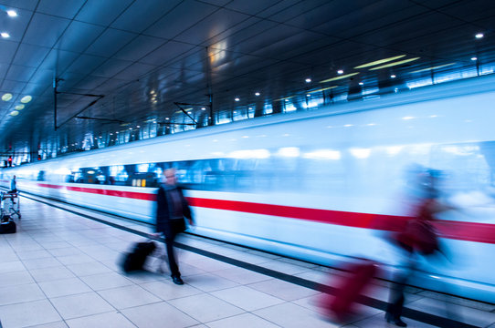 Defocuse Movement Of Fast German Train And Defocused Business People Movement In Rush Hour Train Station