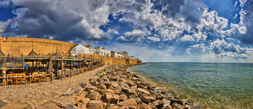 HAMMAMET, TUNISIA - OCT 2014: Cafe on stony beach of ancient Med