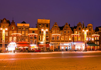 Fototapeta na wymiar AMSTERDAM, NETHERLANDS - January 3, 2016: Amsterdam houses at ch