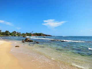 Empty beach with greens, rocks and sand, Sri Lanka