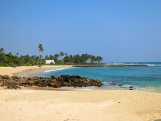 Empty beach with greens, rocks and sand, Sri Lanka