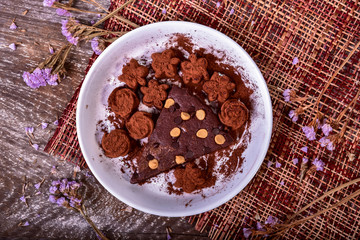 Cake chocolate brownies and dark chocolate on wooden background