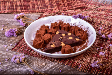 Cake chocolate brownies and dark chocolate on wooden background