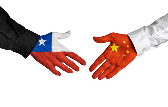 Chile and China leaders shaking hands on a deal agreement