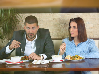 Young couple in love enjoying a romantic dinner at the restaurant