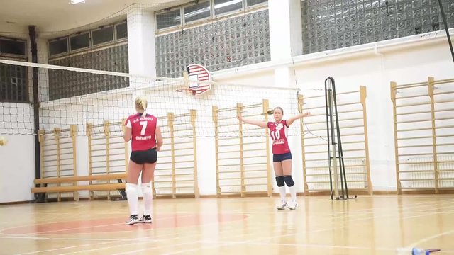 group of girls playing volleyball sport in gym