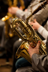  Detail baritone saxophone in the hands of a musician in the orchestra 