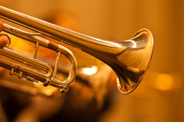Fototapeta na wymiar Detail of the trumpet closeup in golden tones