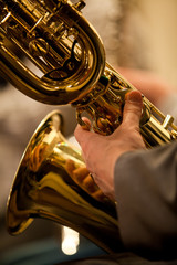  Detail baritone saxophone in the hands of a musician in the orchestra