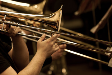  Hands of man playing the trombone in the orchestra