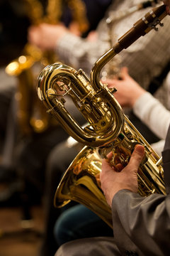  Detail baritone saxophone in the hands of a musician in the orchestra 