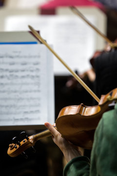  Fragment of a violin in the hands of a musician in the symphony orchestra