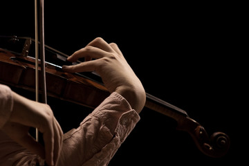 Hand violinist closeup on a black background