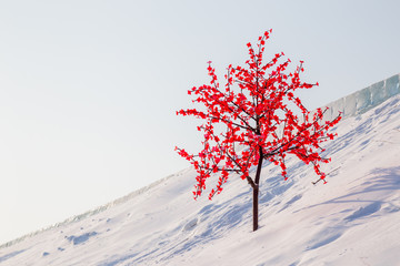 Artificial tree on snow hill