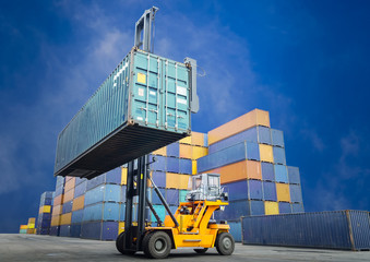 Forklift handling container box loading to freight train