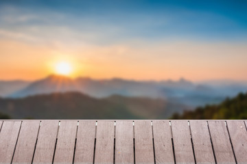 Naklejka na ściany i meble Wood table top on Majestic sunset in the mountains landscape