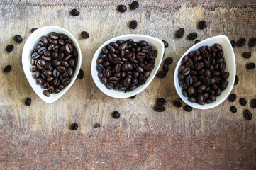 Fototapeta na wymiar Coffee beans on rustic background