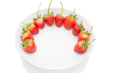 Red strawberries on white plate with white background